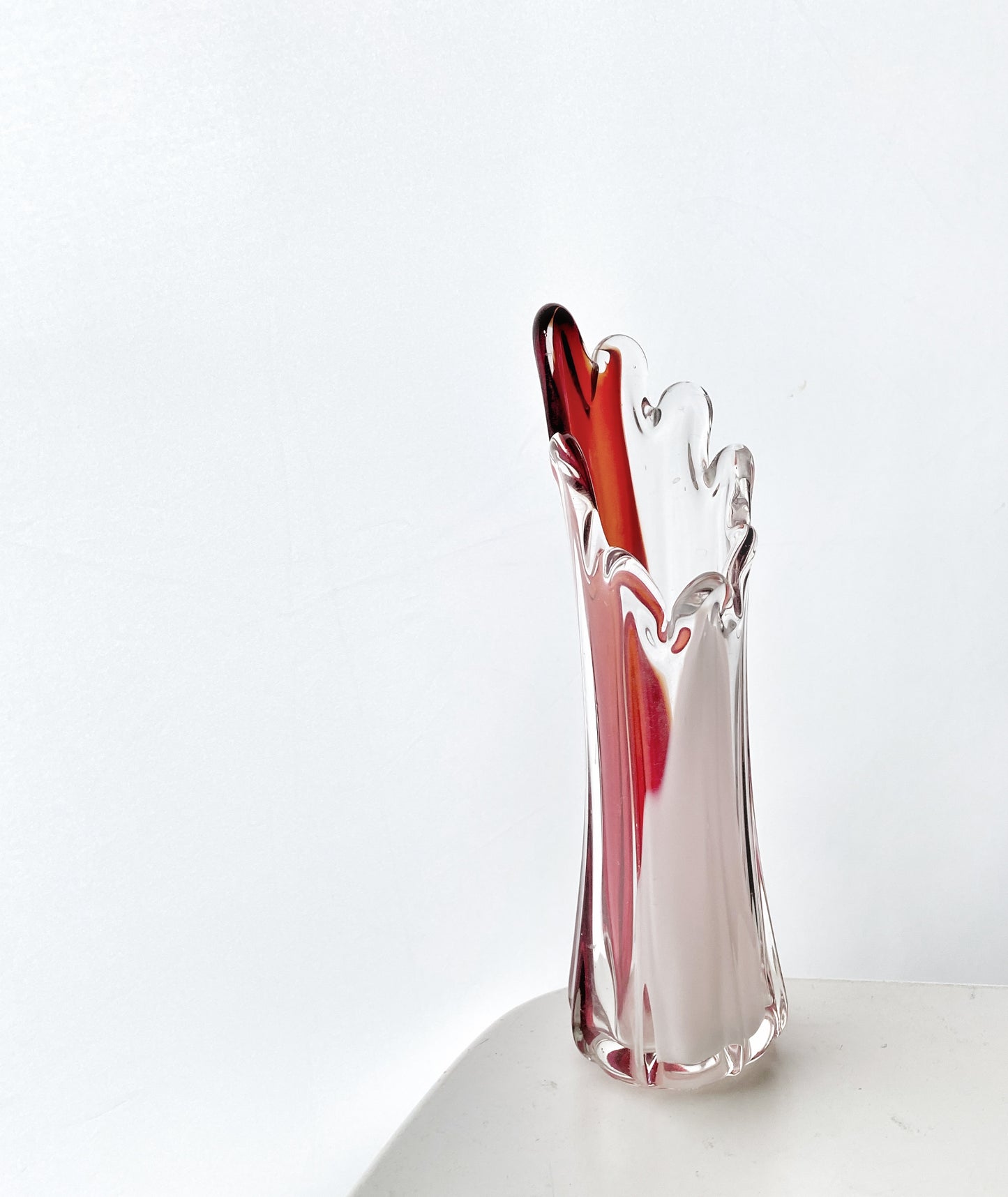A Murano Art Glass vase, organic form, clear with white, and red tint