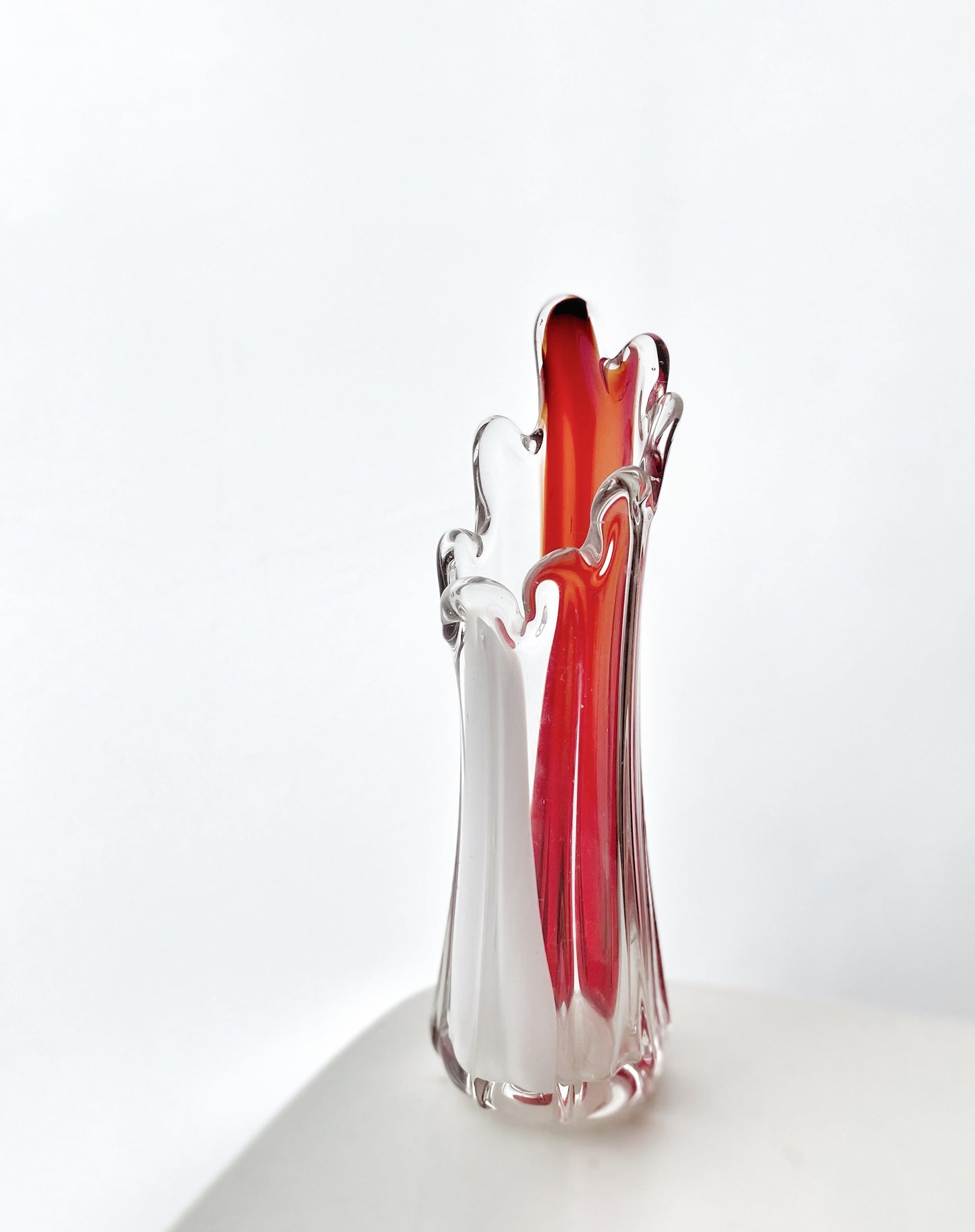 A Murano Art Glass vase, organic form, clear with white, and red tint