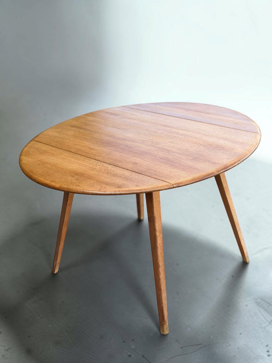Early Ercol elm drop-leaf table after careful conservation, with its tactile grain and original patina retained.