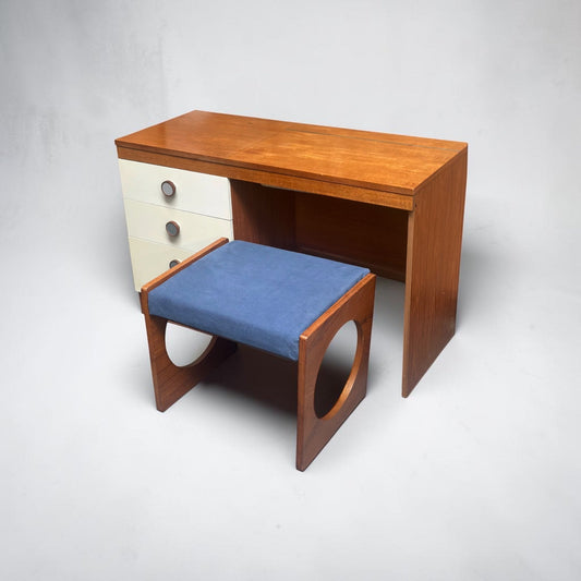 Uniflex F-Range teak dressing table and matching stool, united by a repeated circular motif.